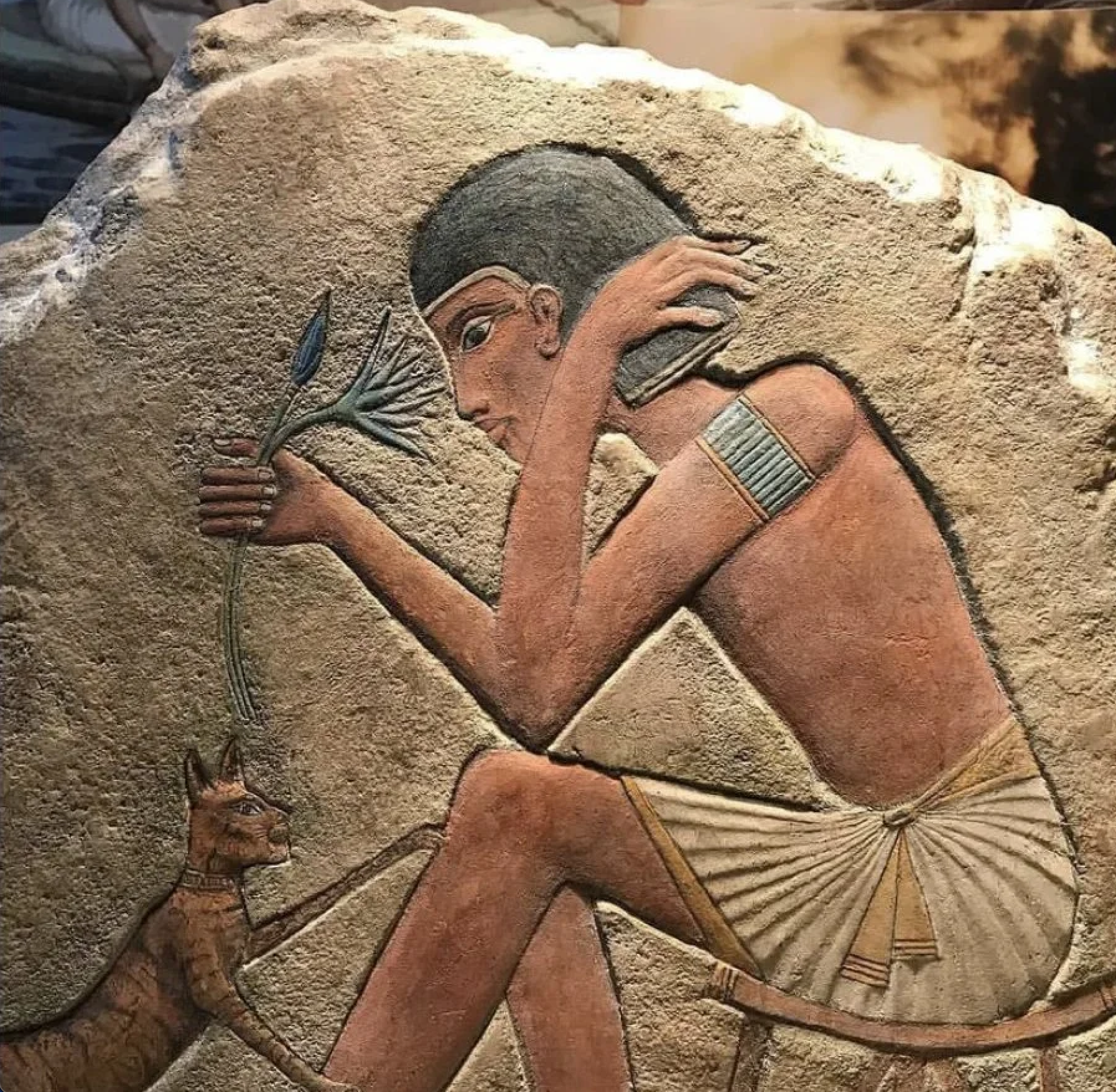Egyptian relief of figure holding blue lotus flower